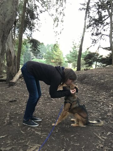 Holly gives Hana a head smooch during a walk at McLaren Park
